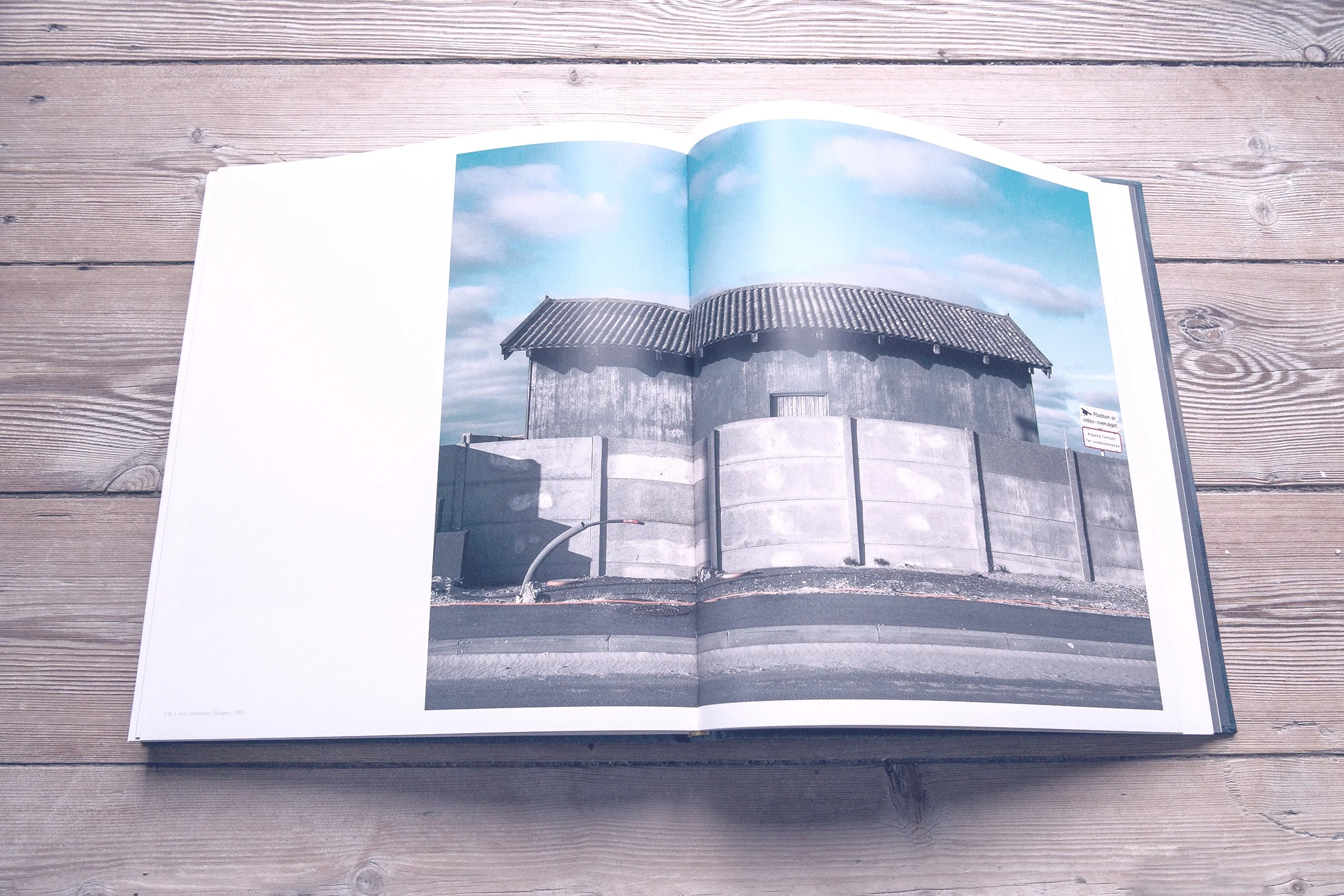 Book spread with a rounded concrete building