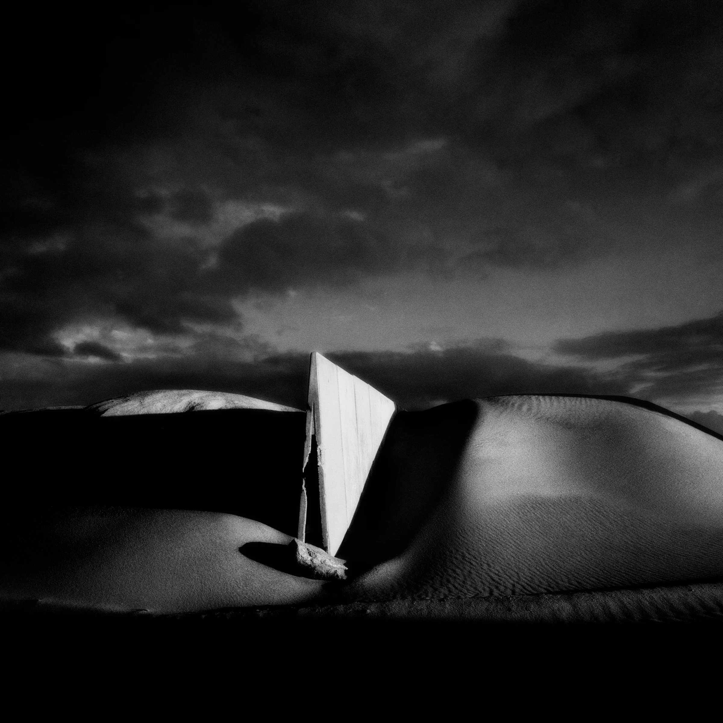 Concrete structure beneath dark clouds