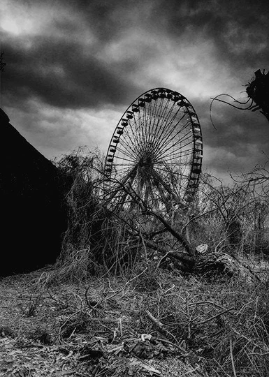 Ferris wheel beneath a cloudy sky at Spreepark